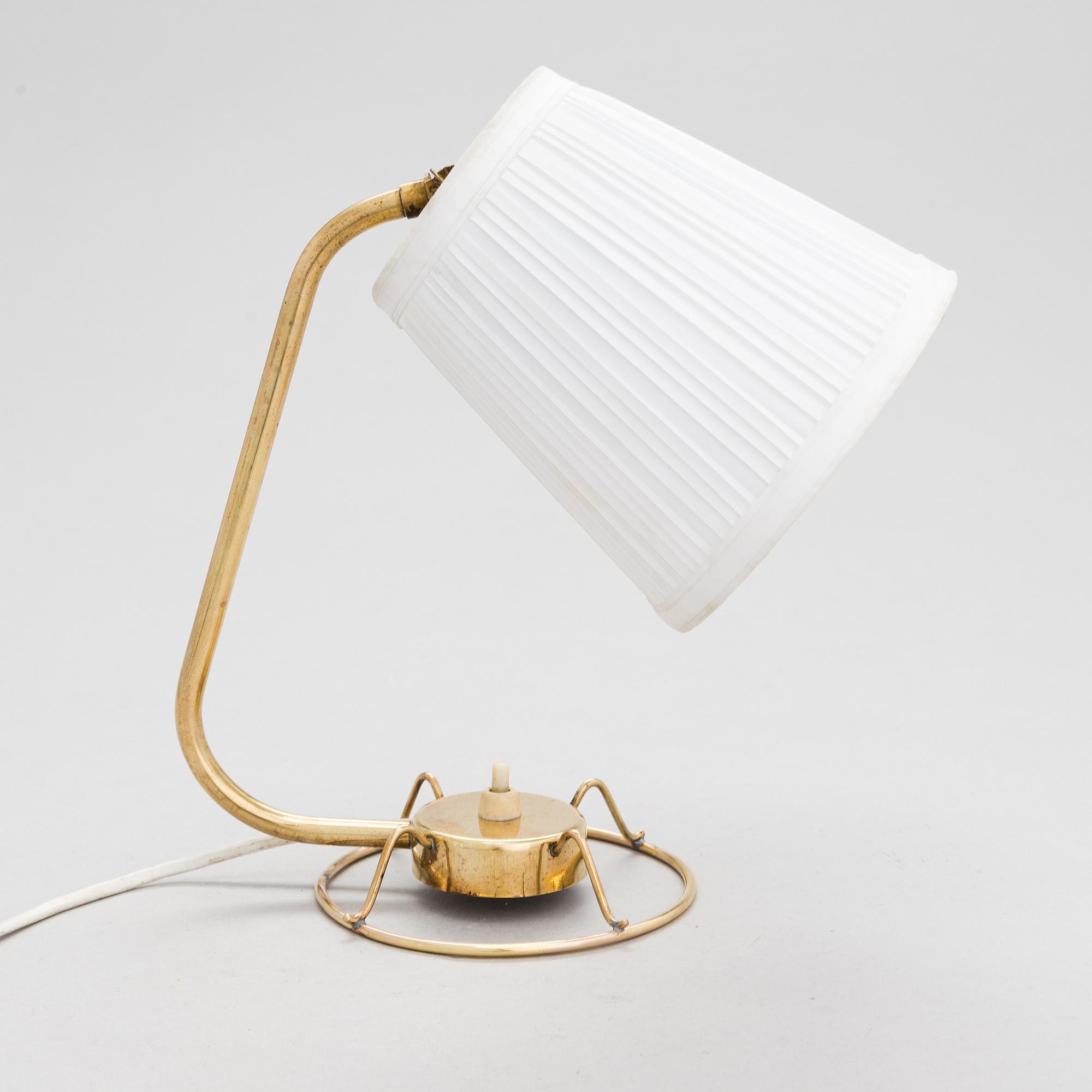 A mid-20th-century table lamp
/wall light for Idman.