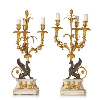 162. A pair of three-light Louis XVI patinated and ormolu candelabra in the manner of François Rémond, late 18th century.