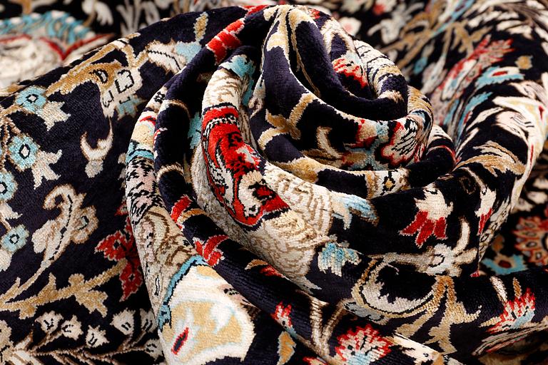 A Ghom silk carpet, approx. 309 x 200 cm.