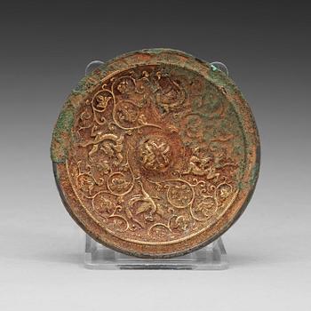 21. A gilt bronze mirror, presumably Tang dynasty (618-907).