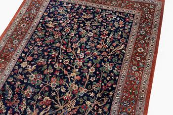 A signed pictoral silk Qum rug, c. 203 x 127 cm.