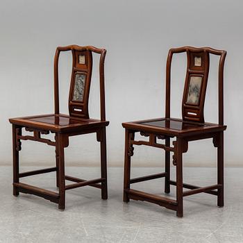 A pair of Chinese hardwood armchairs, early 20th century.