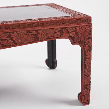 A carved lacquered table, early 20th Century.