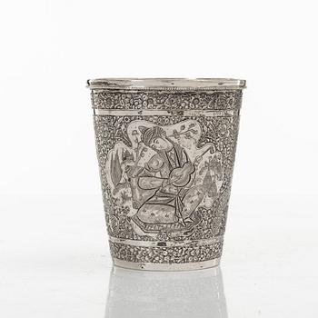 A Persian silver pitcher with five stemmed cups and a beaker, first part of the 1900s.