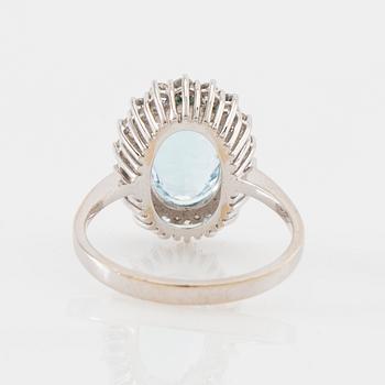 Ring 18K white gold set with an oval faceted aquamarine and round brilliant-cut diamonds.