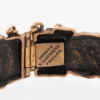 A bronze bracelet set with amethysts by Pentti Sarpaneva.
