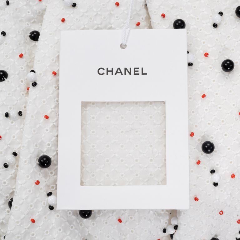 Chanel, a pair of broderie anglais trousers with pearls, size 34.