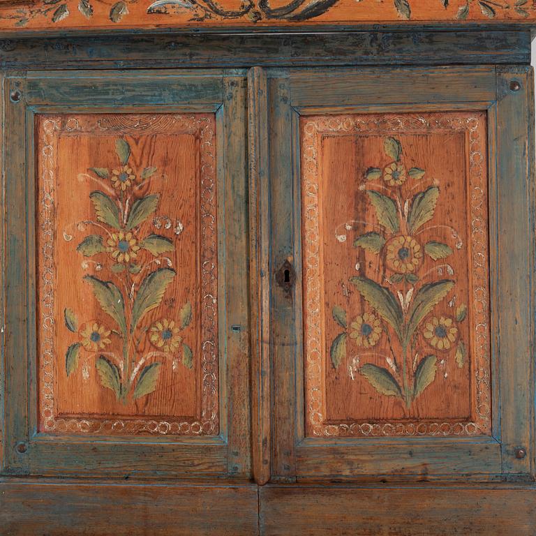 A painted cabinet, dated 1825.