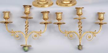 A matched pair Empire early 19th century gilt bronze candelabra/candlesticks. Including one empire candlestick.