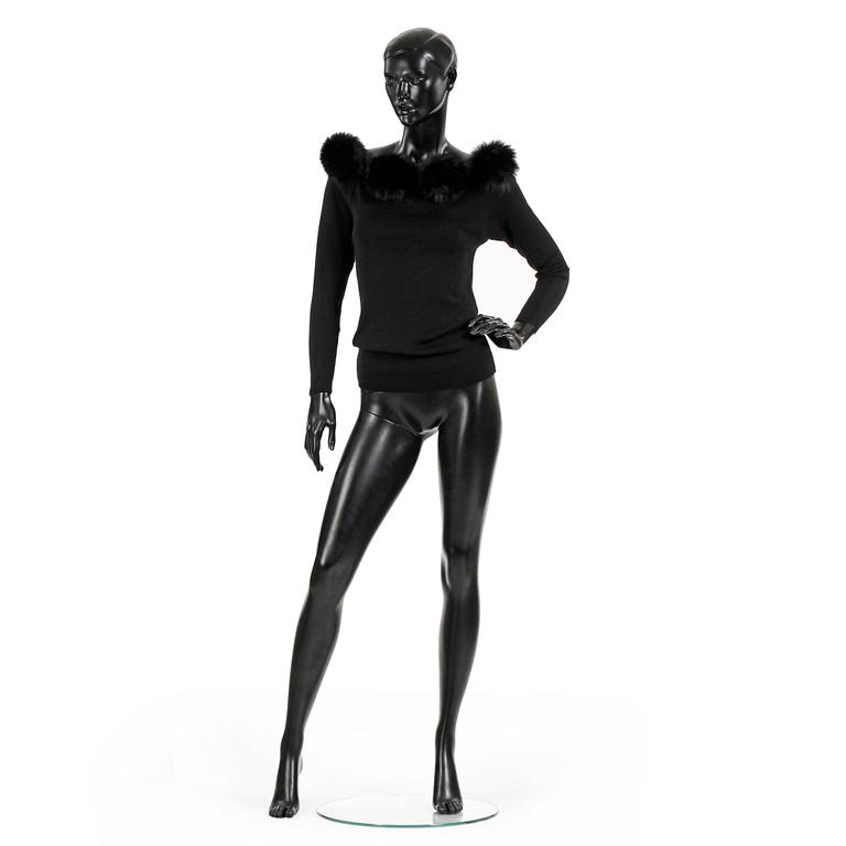 YVES SAINT LAURENT, a black wool sweater with fox pompons.
