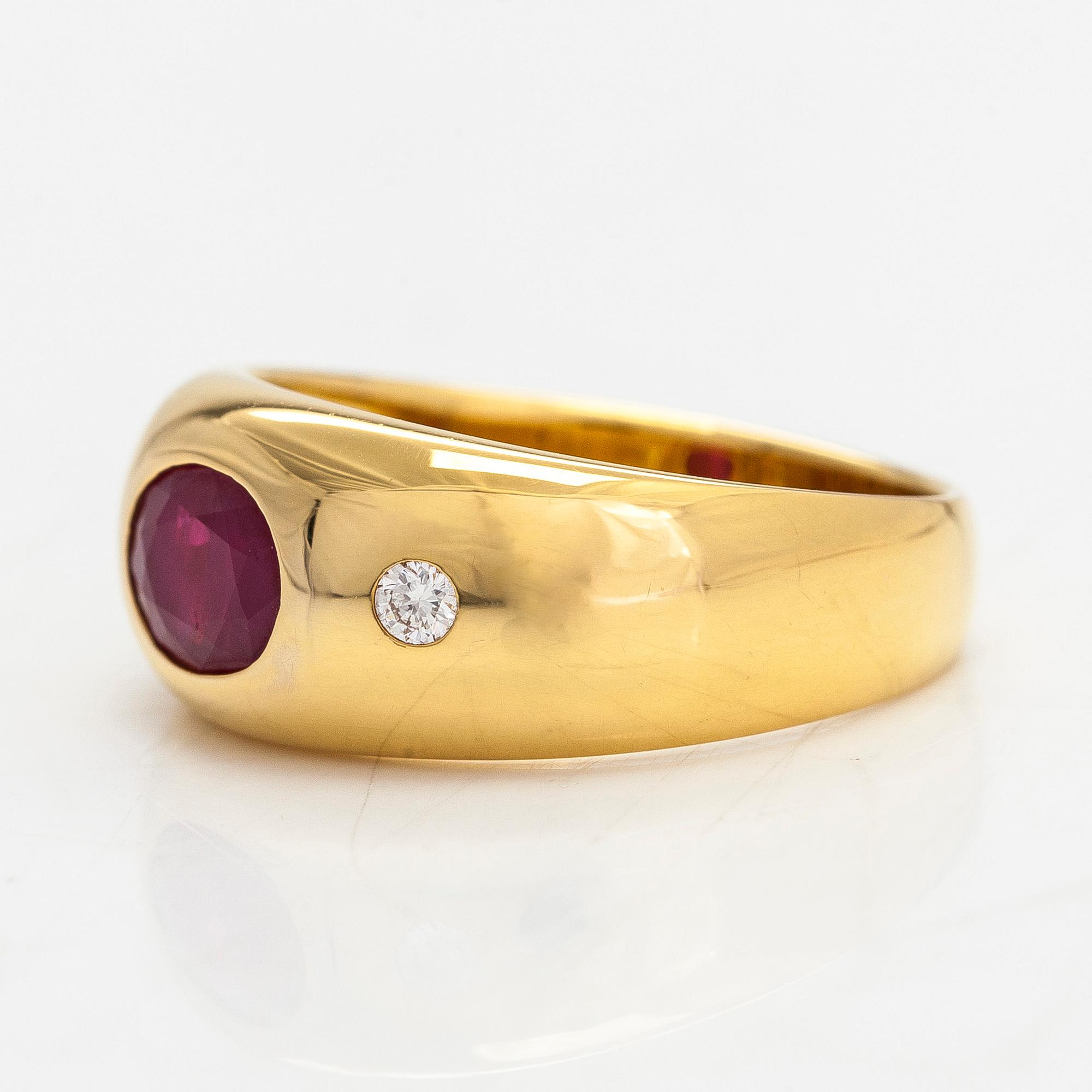 A 14K gold ring, set with an oval-cut ruby and diamonds totaling approx. 0.06 ct. Finland, 1999.