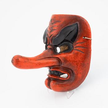 A red-lacquered Tengu mask, Japan, Meiji/Taisho period, early 20th Century.