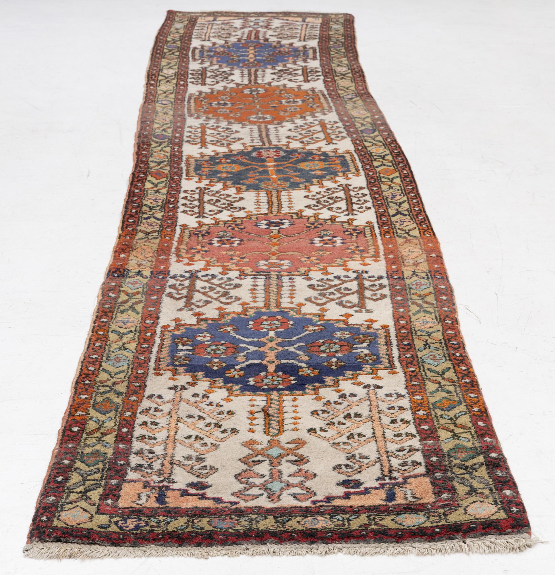 An oriental runner, c. 395 x 82 cm.