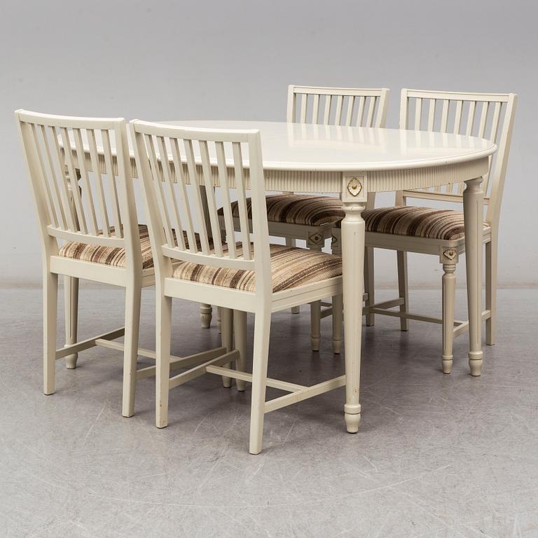 A dining table and 4 chairs, second half of the 20th century. 2 leaves included.