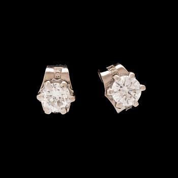 A pair of 18K white gold earrings set with round brilliant cut diamonds.
