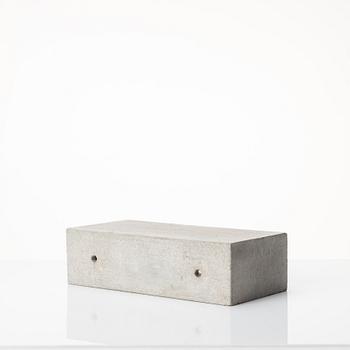 Stina Lindholm, a contemporary concrete planter 'Spira', a concrete flower pot and a wall clock.