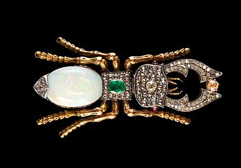 449. BROOCH, opal c. 13.00 ct, emerald c. 0.5 ct, old cut diamonds c. 1.6 ct, rubies.