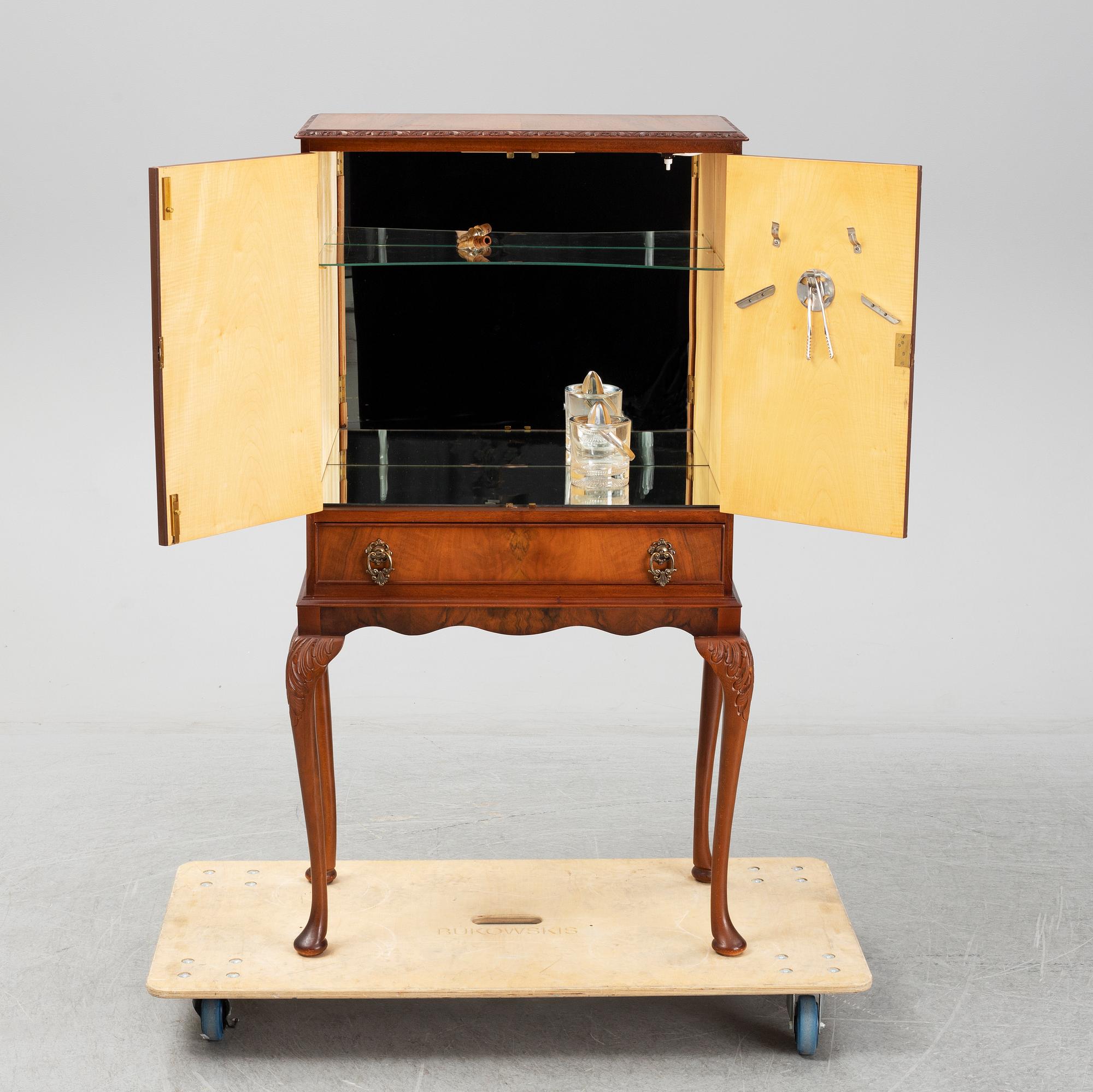 A mid 20th century walnut veneered bar cabinet.