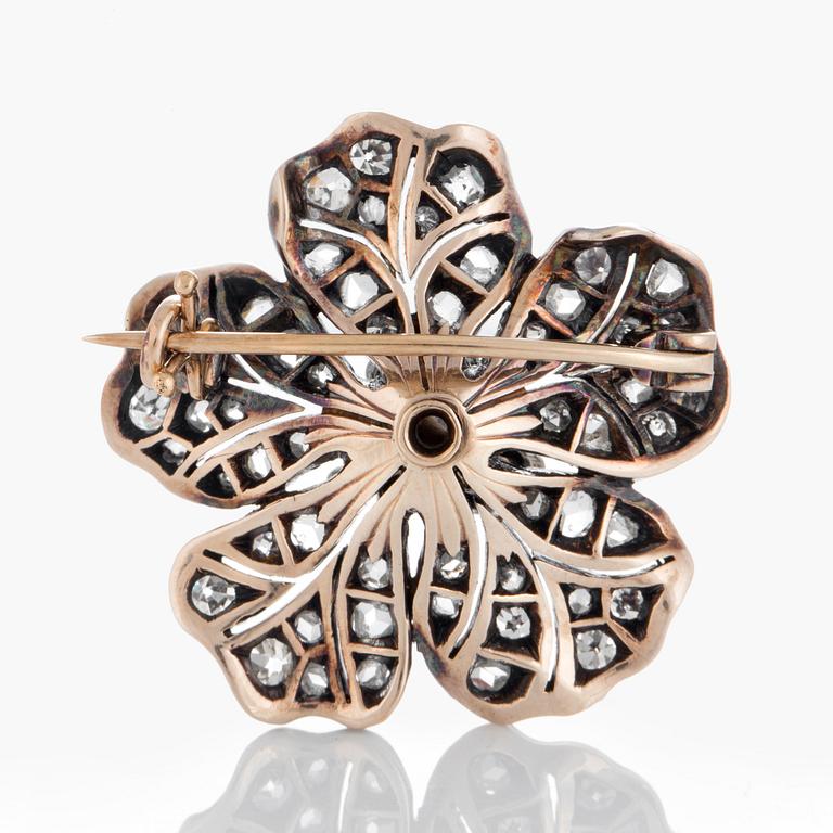 A flower brooch set with old-, eight- and rose-cut diamonds.