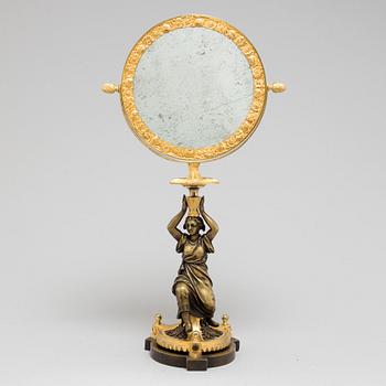 AN EMPIRE ORMOLU TABLE MIRROR, first half of the 19th century.