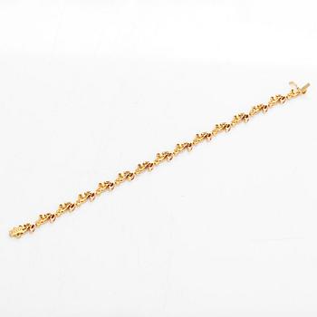 An 18K gold bracelet, with diamonds and rubies.