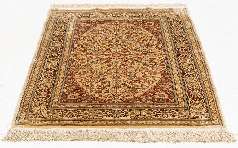 A silk Hereke rug, circa 104 x 70 cm.