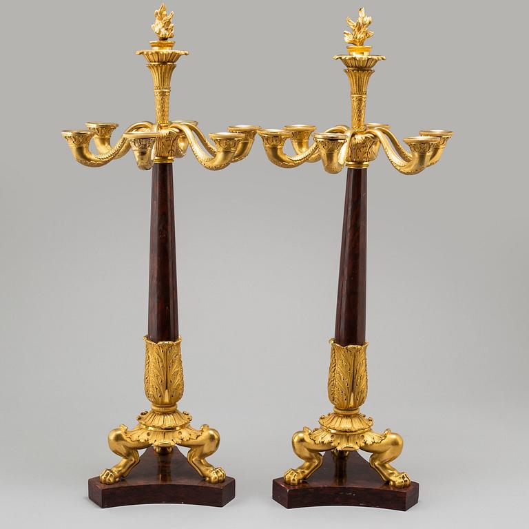 A pair of mid 19th century late Empire bronze and marble candelabra.