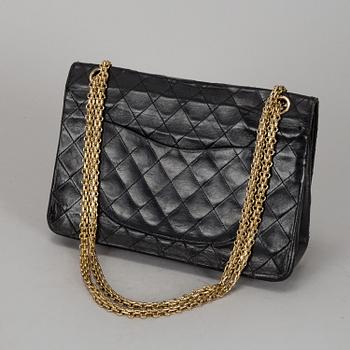 CHANEL, a quilted black leather 'Double Flap Bag'.