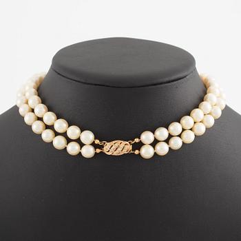 Necklace of two strands of cultured pearls, clasp with 18K gold lock set with eight-cut diamonds.