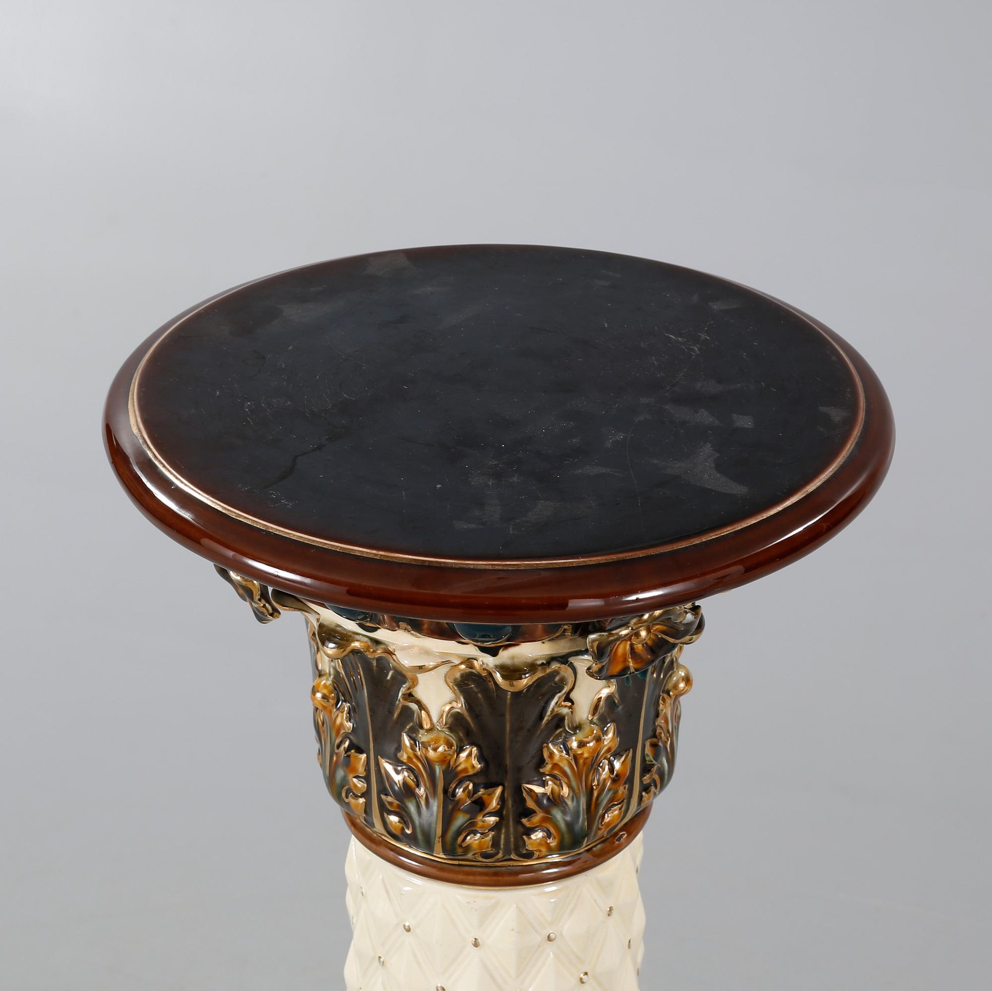 A Rörstrand pedestal with pot in majolica, made around year 1900.