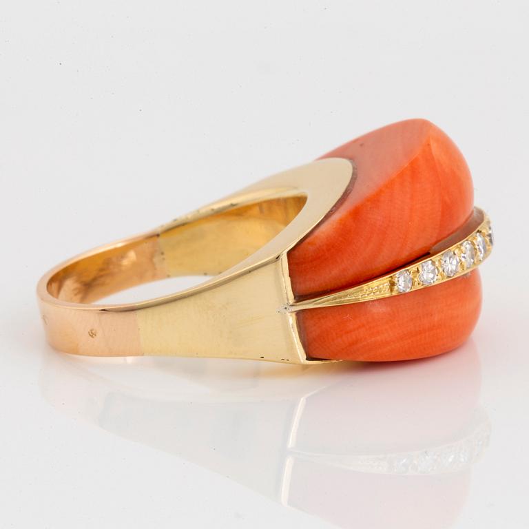 An 18K gold and coral ring set with eight-cut diamonds.