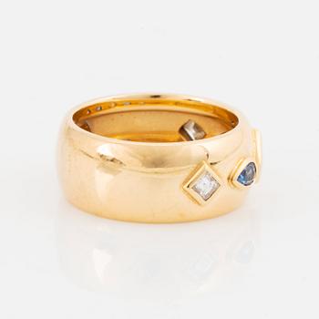 An 18K gold Cartier ring set with step-cut diamonds and faceted sapphires.