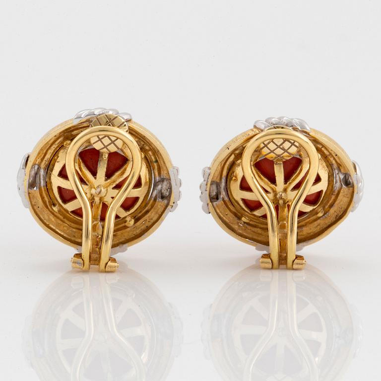 A pair of 18K gold and white gold earrings set with coral.