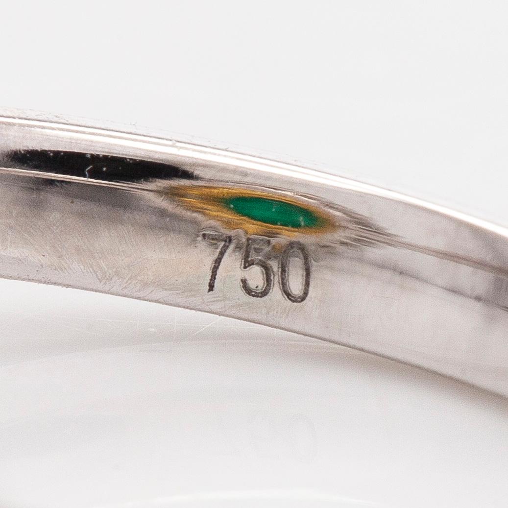 An 18K whitegold ring set with a cabochon-cut emerald and baguette- and brilliant-cut diamonds.