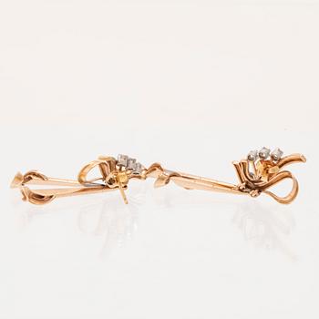 A pair of 18K white and red gold earrings set with single cut diamonds.