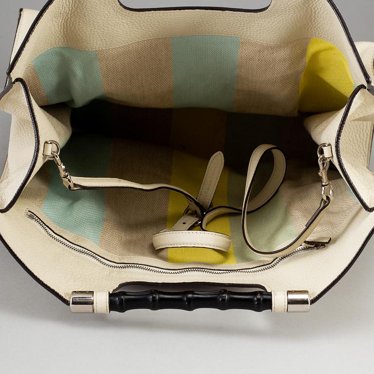 GUCCI, a white leather tote bag with bamboo handles.