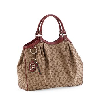GUCCI, a monogram canvas and red leather tote bag, "Sukey".