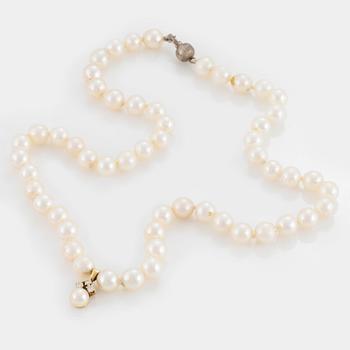 A necklace of cultured pearls with a pendant set with round, brilliant-cut diamonds and a silver clasp.