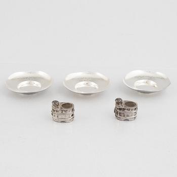 A set of three Japanese silver coasters and a pair of salts with shakers, 20th century.