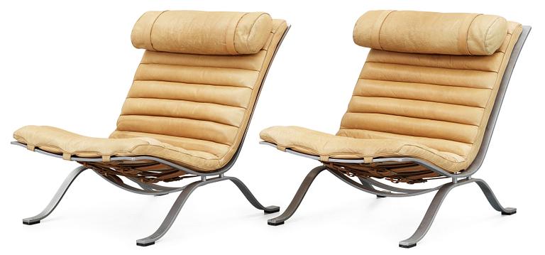 A pair of Arne Norell "Ari" brown leather and steel easy chairs by Norell.