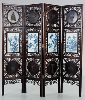 A four panel screen with porcelain placques, Qing dynasty, 19th Century.