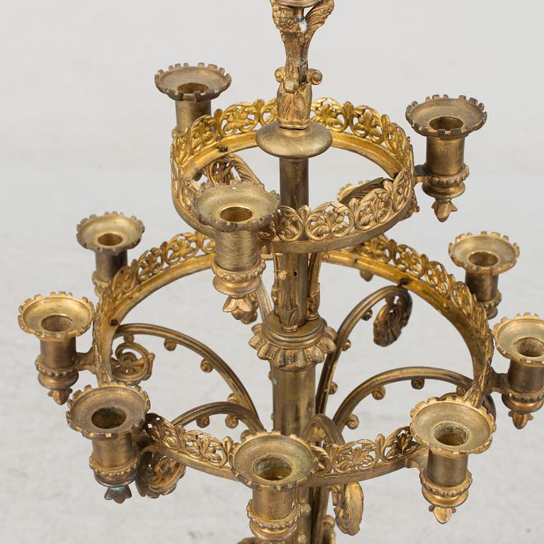 Two similar 19th century bronze candelabras.