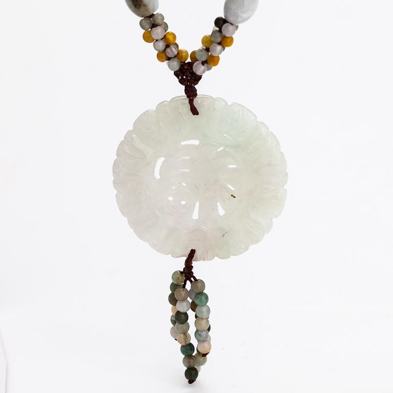 A collier with jade and nyon cord.