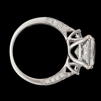 A princess cut diamond ring, 4.03 cts. and smaller brilliant cut diamonds.