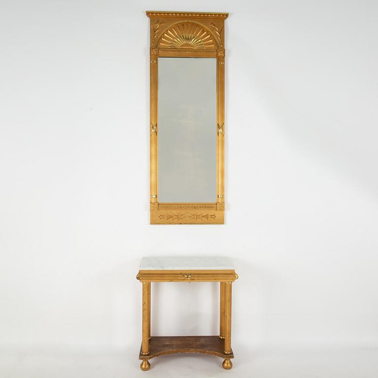 An Empire style mirror and a console table, first half of the 20th century.