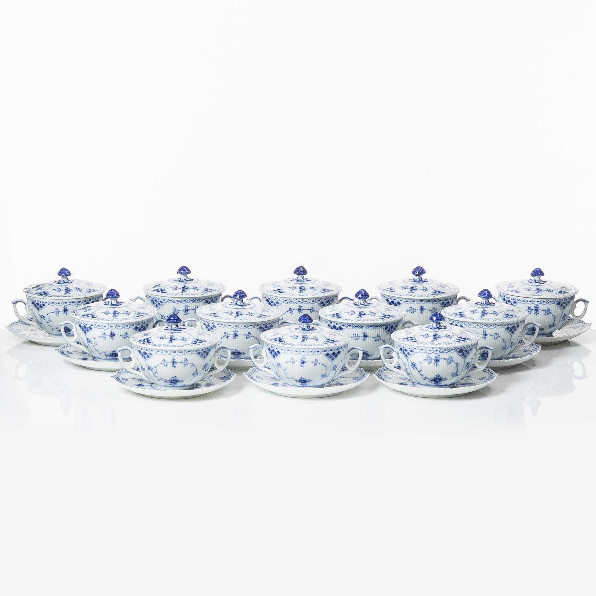 Royal Copenhagen, twelve consommé cups with saucers, 'Blue Fluted Half Lace', Denmark.