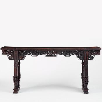 A massive zitan recessed-leg long table 'Jiaotousun Qiotouan', Qing dynasty, 19th century.