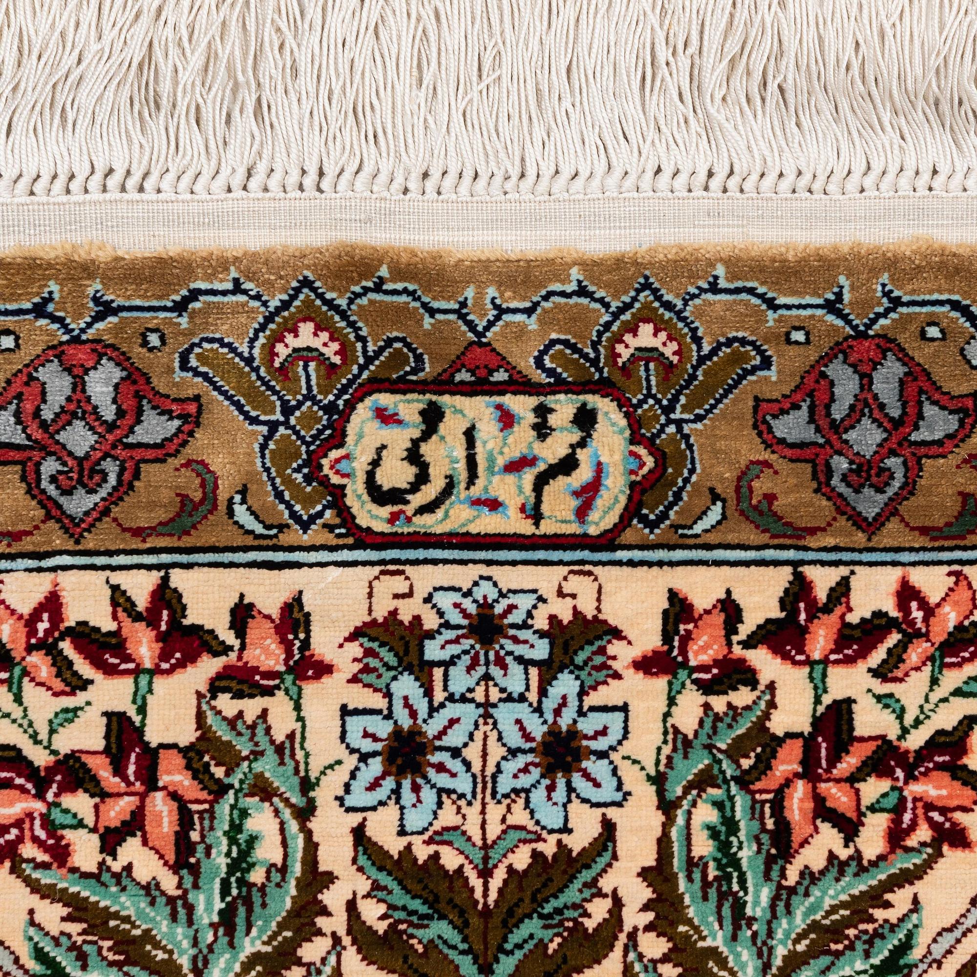 A silk Qum rug, Central Persia, signed, c. 135 x 208 cm.