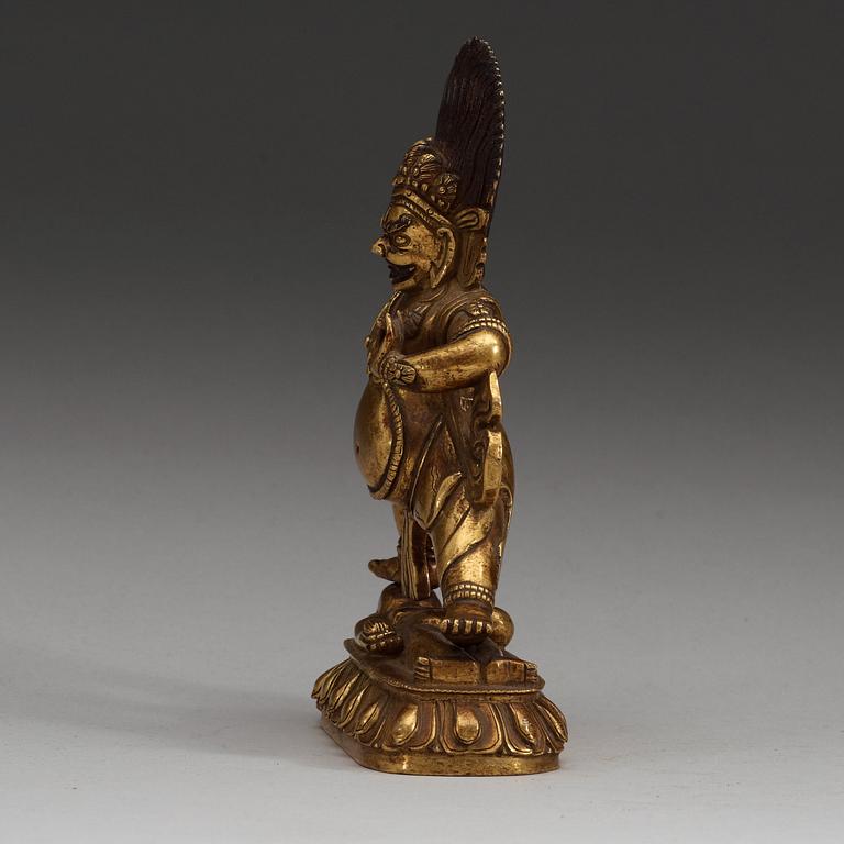 A Sinotibetan gilt bronze figure of a Dharmapala, Qing dynasty, 19th Century.