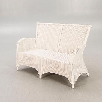 An Artwood rattan sofa.